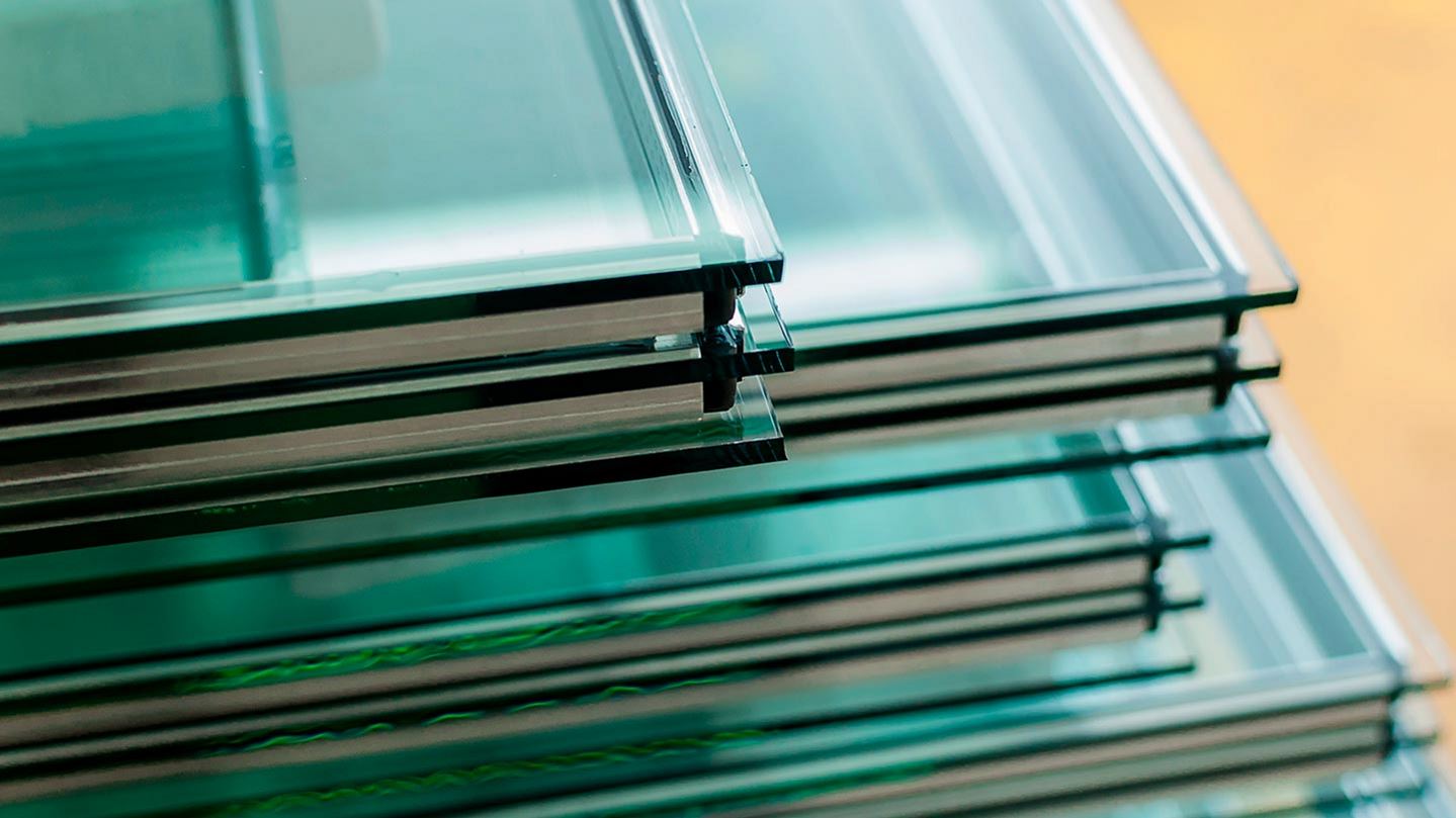 Triple-pane glass for windows, stacked on a pile. Krypton, xenon and rare gas mixtures are used in double and triple-pane insulated window production.