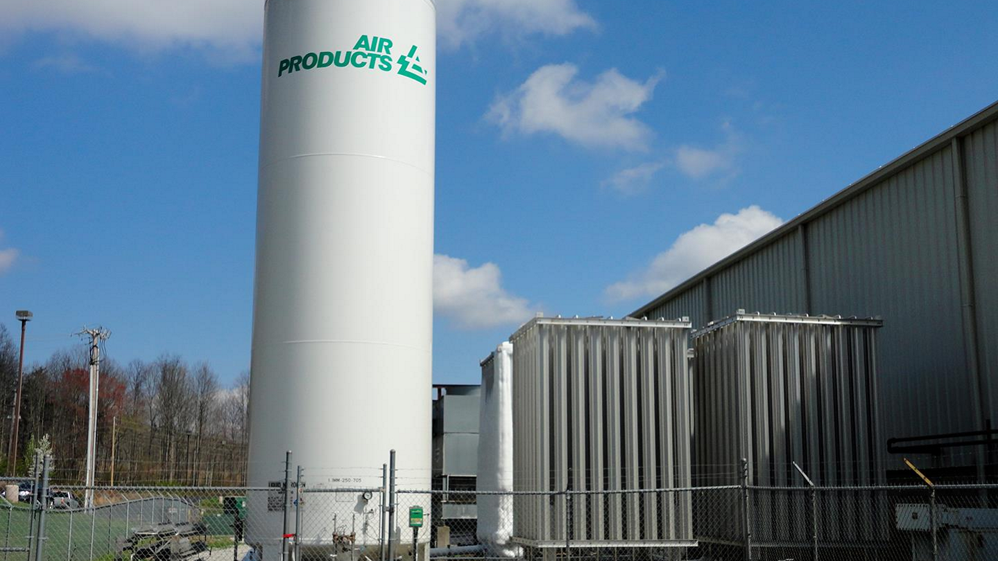 Air Products cryogenic liquid tank and vaporizer beside a manufacturing facility