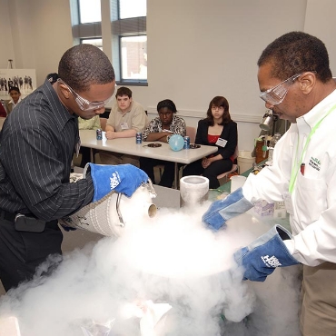 Employees conducting liquid nitrogen demonstration