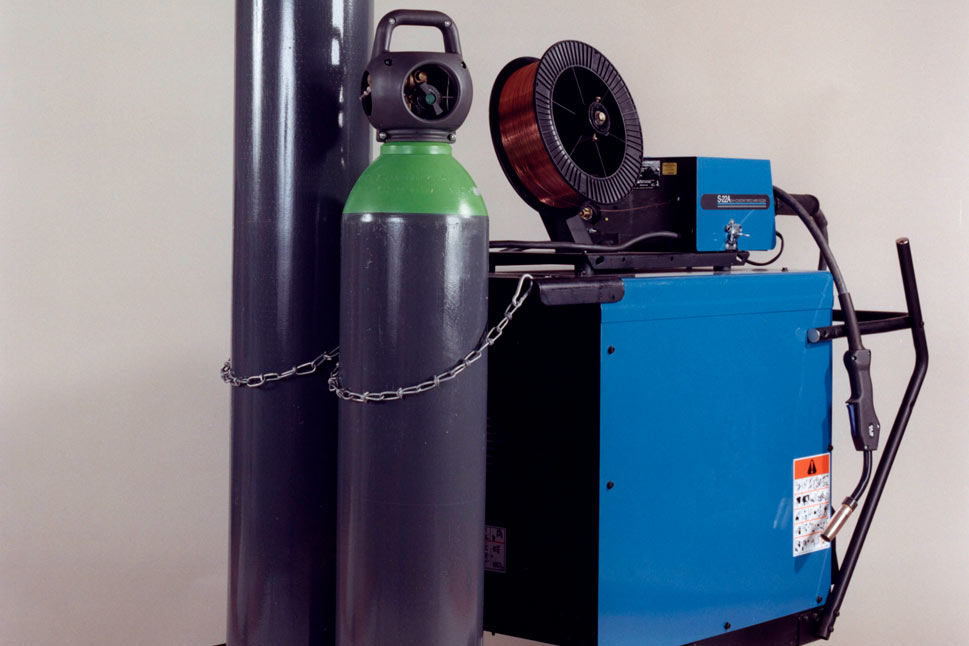 Integra cylinder next to standard welding cylinder attached to a welding machine